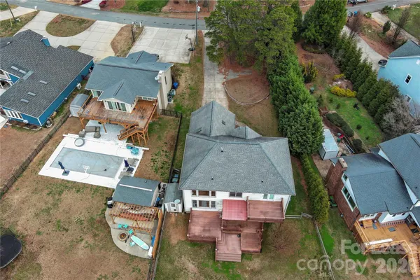 an aerial view of a house with garden space and street view