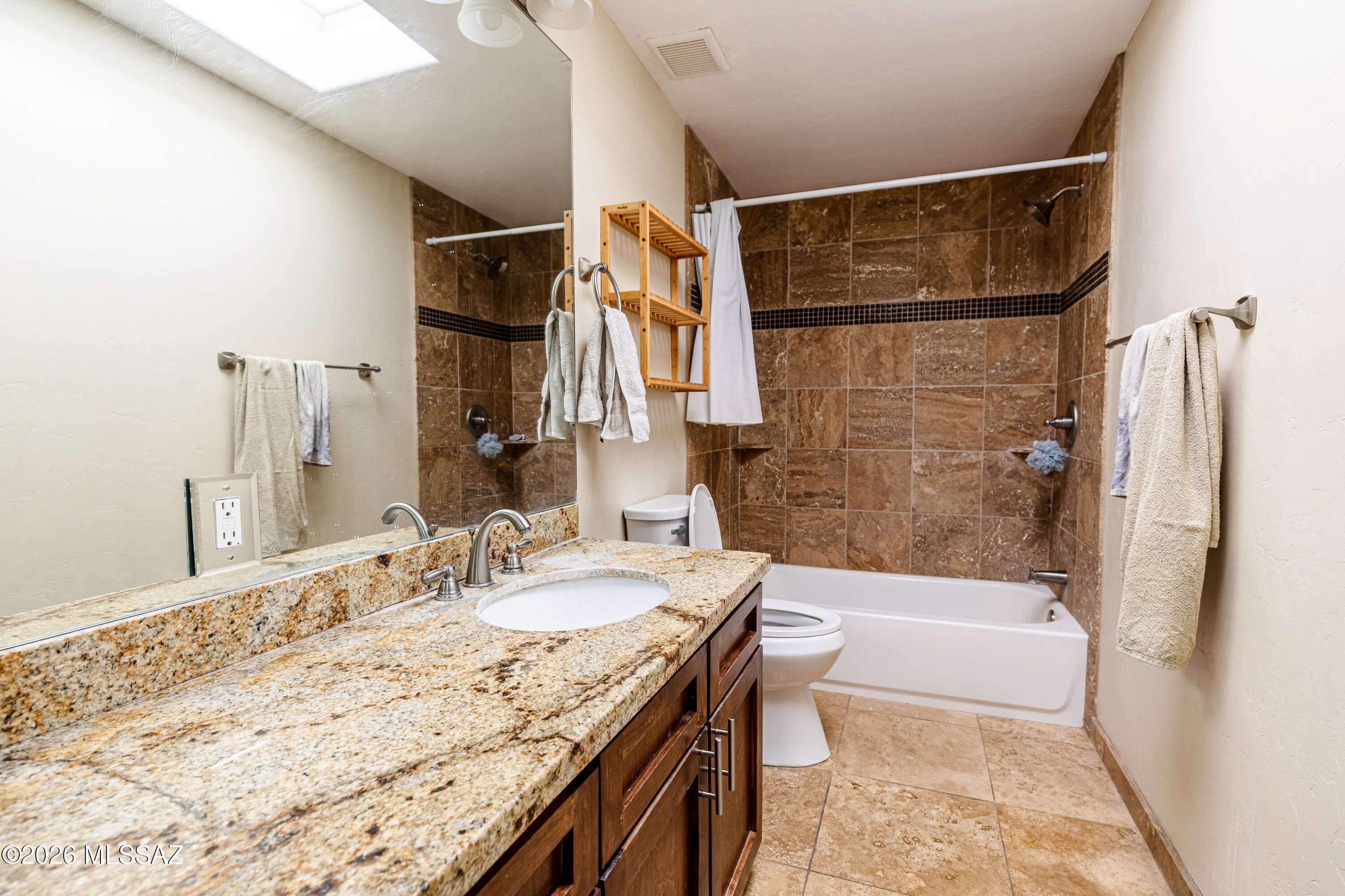545 East Rancho Catalina Place Tucson, AZ 85704 - Photo 10 of 13 a bathroom with a granite countertop sink a toilet and shower