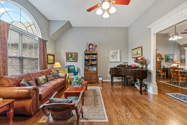 a kitchen with stainless steel appliances granite countertop a stove a sink dishwasher and cabinets with wooden floor