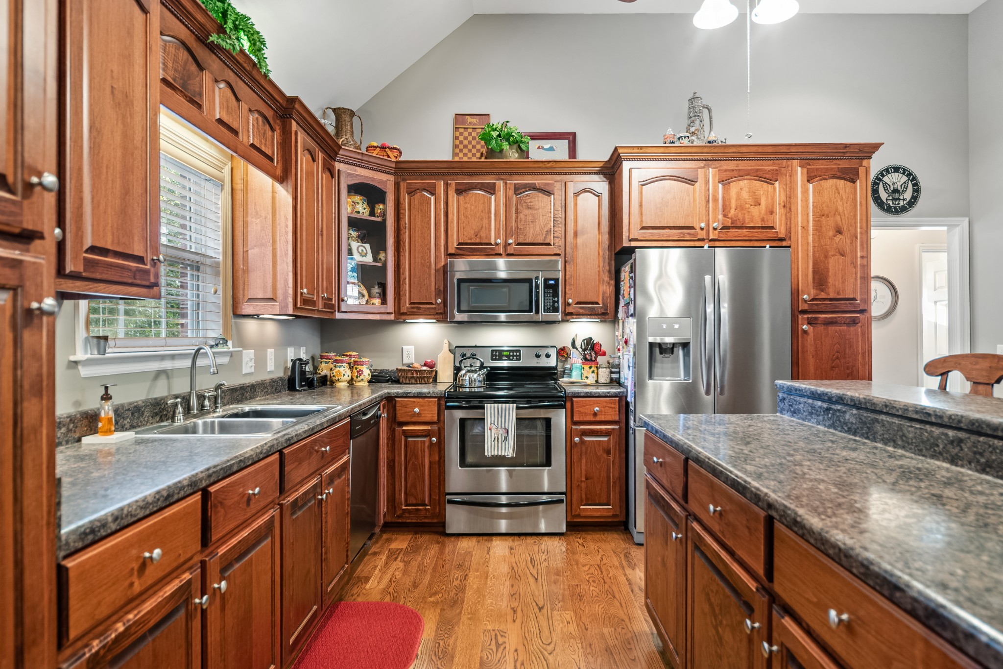 4862 Toll Dugger Road Culleoka, TN 38451 - Photo 25 of 96 a kitchen with stainless steel appliances granite countertop a stove a sink and a refrigerator