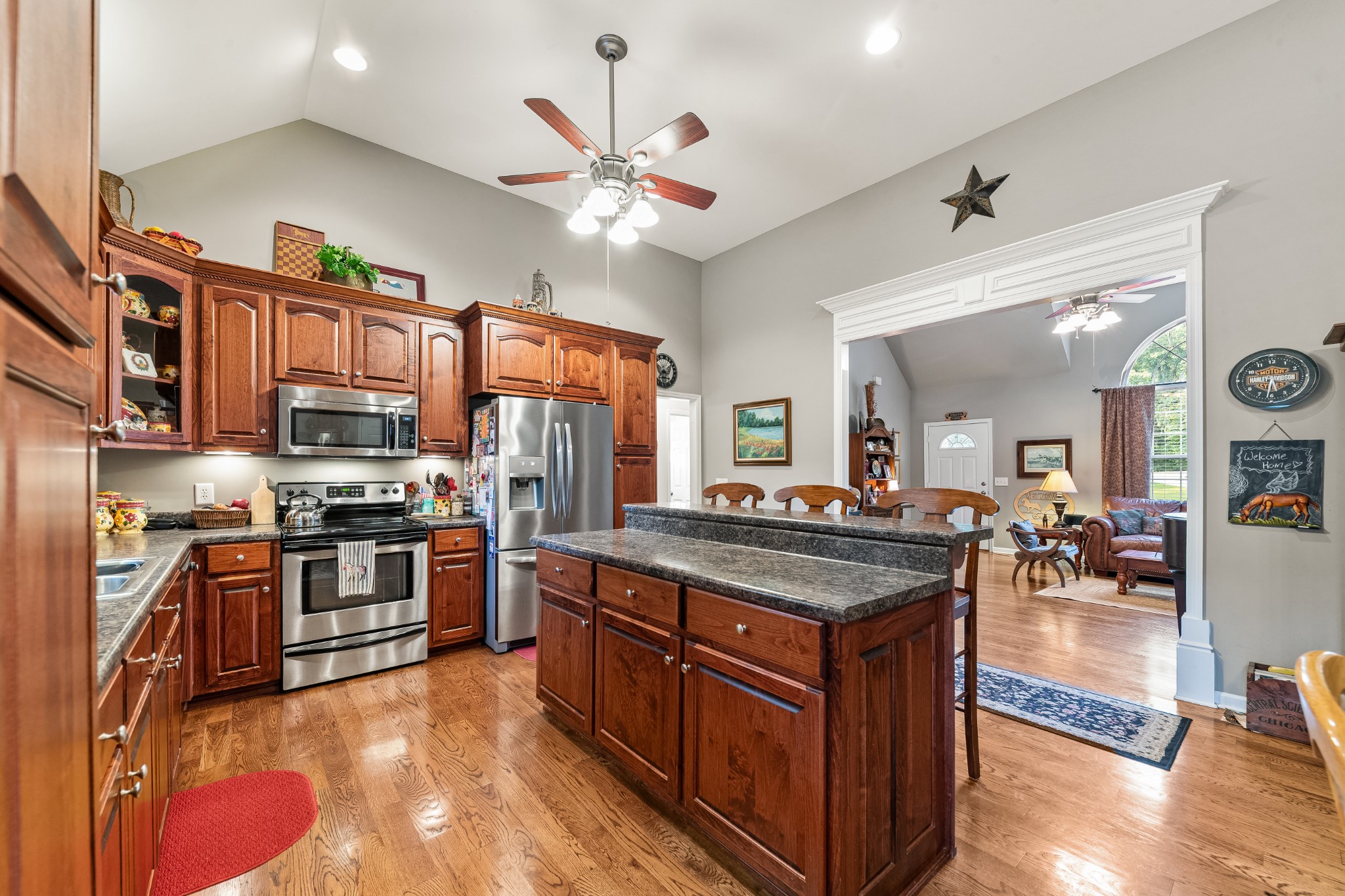 4862 Toll Dugger Road Culleoka, TN 38451 - Photo 26 of 96 a kitchen with stainless steel appliances granite countertop a stove oven and a view of living room