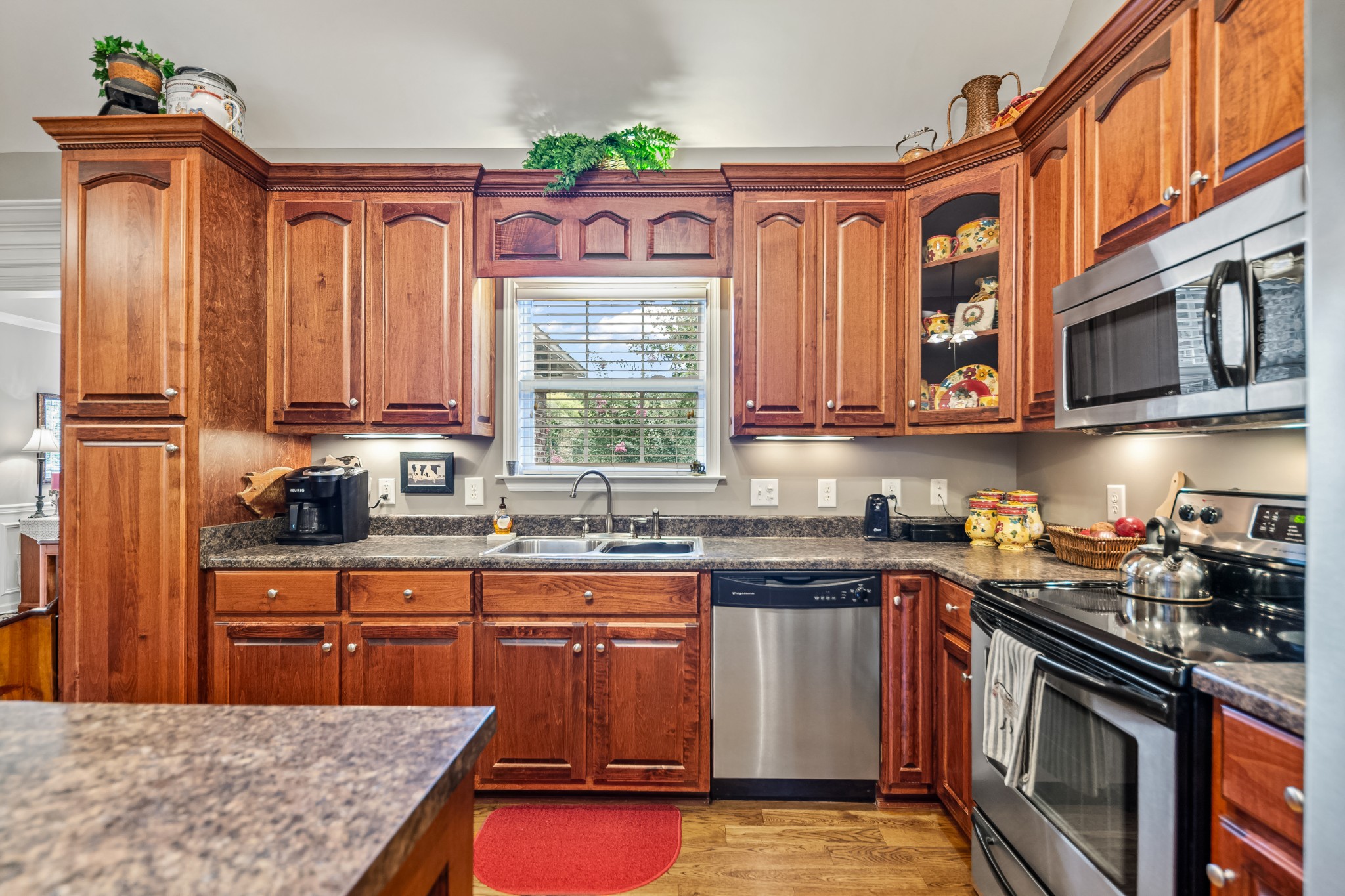 4862 Toll Dugger Road Culleoka, TN 38451 - Photo 27 of 96 a kitchen with stainless steel appliances granite countertop a stove a sink dishwasher and cabinets with wooden floor