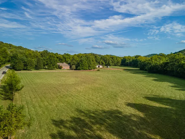 a living room with furniture a wooden floor and a large window