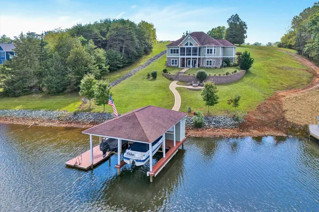 an aerial view of a house with a yard basket ball court and outdoor seating