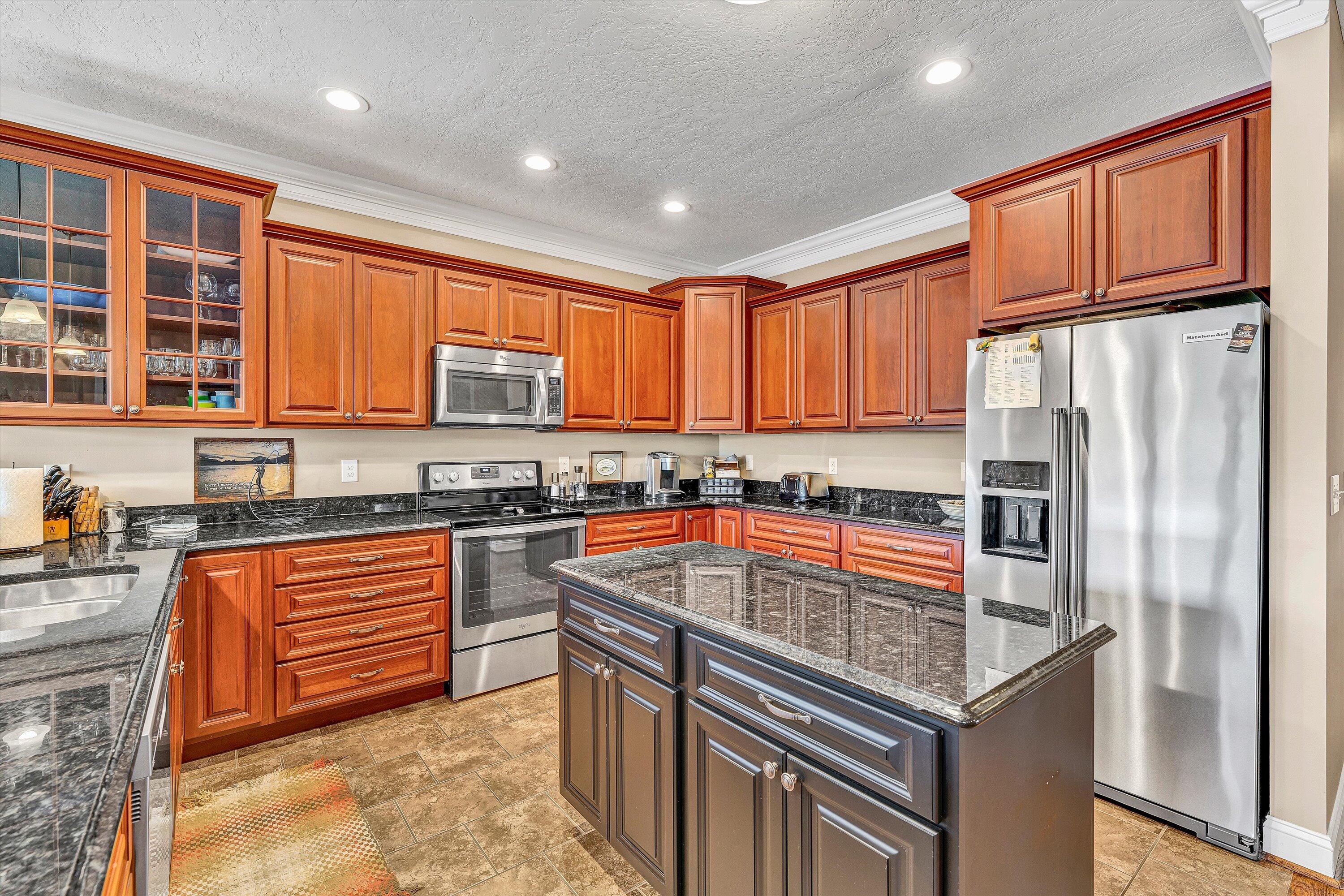 440 Augusta Way Wirtz, VA 24184 - Photo 11 of 63 a kitchen with stainless steel appliances granite countertop a refrigerator a stove and a sink