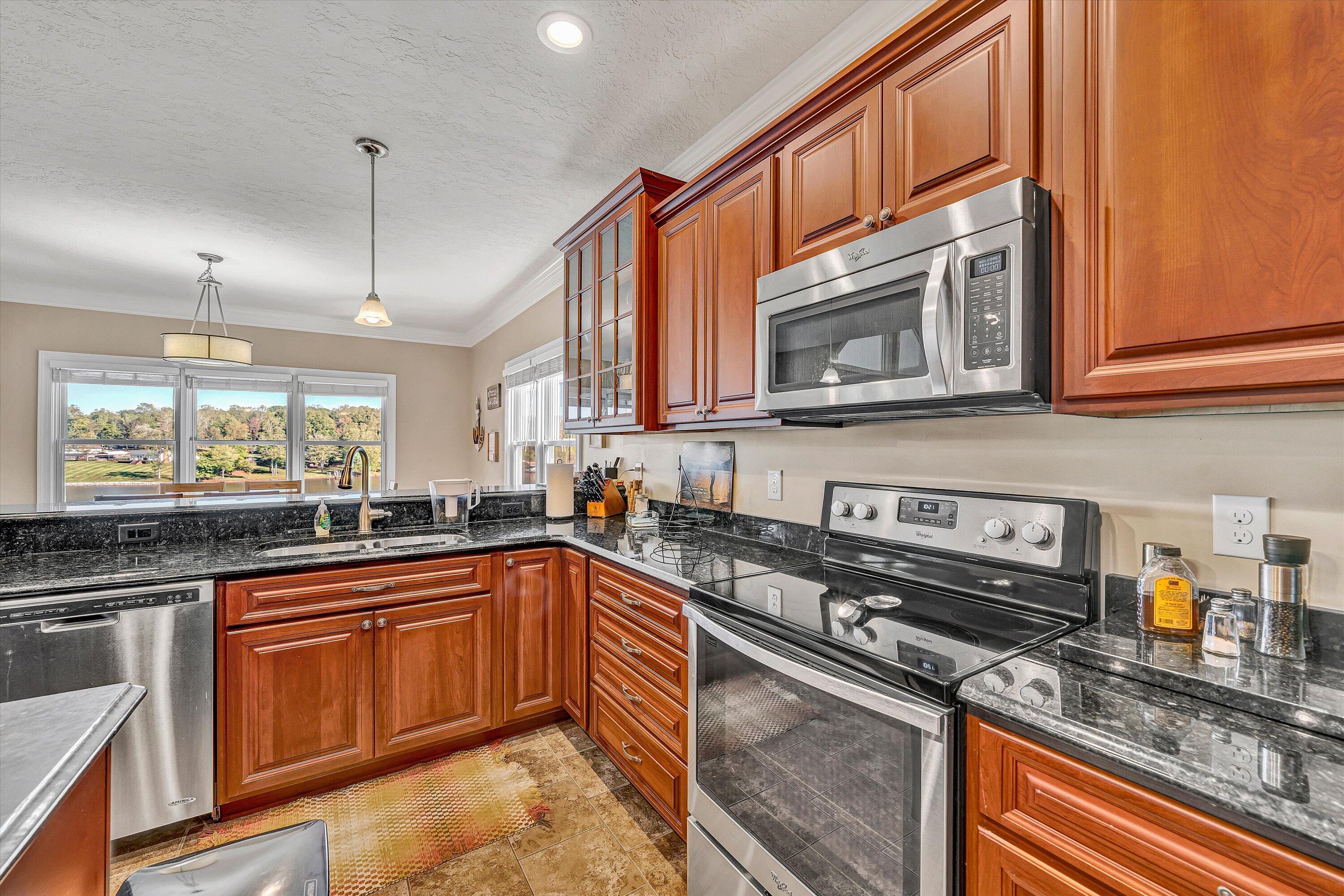 440 Augusta Way Wirtz, VA 24184 - Photo 12 of 63 a kitchen with stainless steel appliances granite countertop a sink stove and microwave