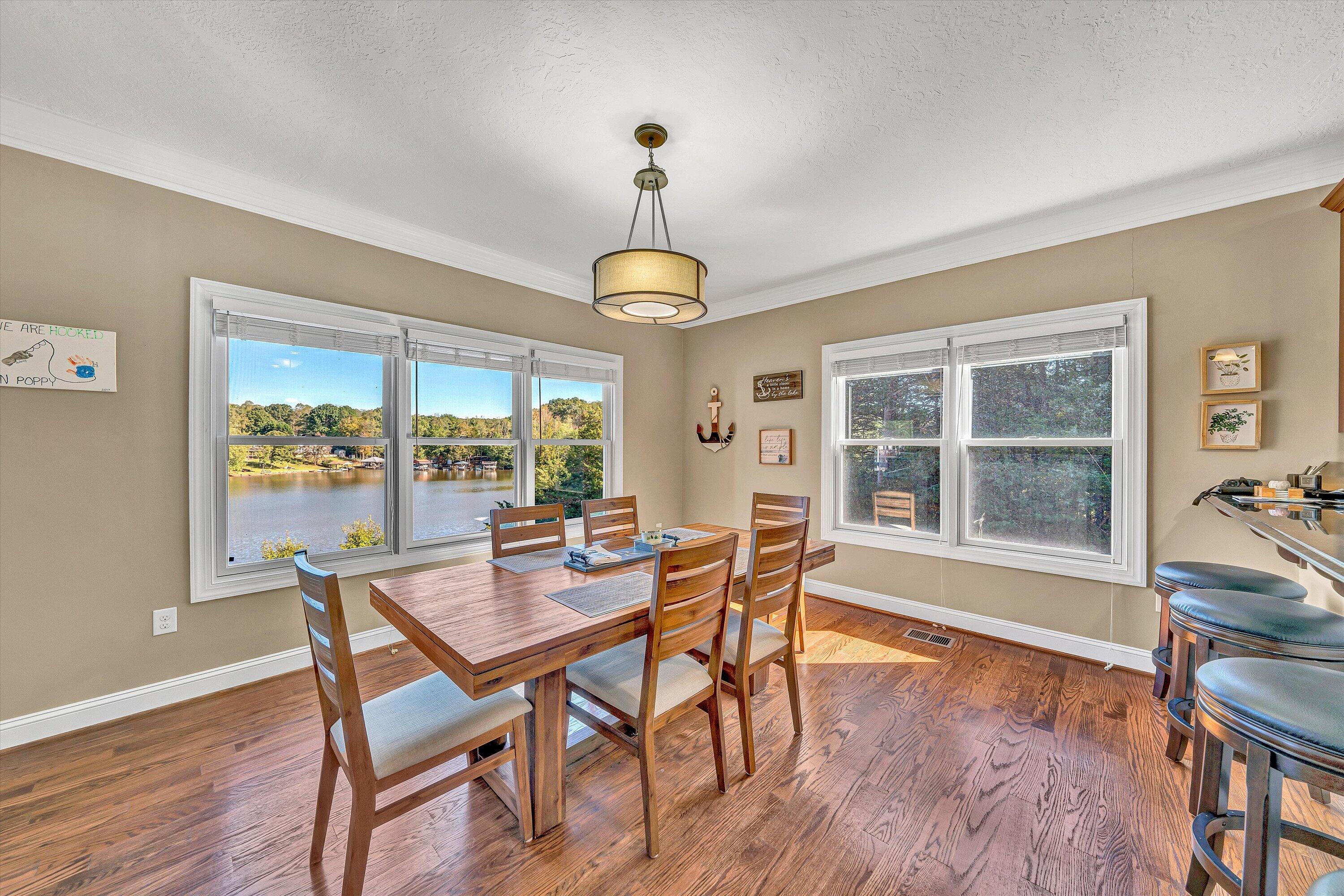 440 Augusta Way Wirtz, VA 24184 - Photo 15 of 63 a dining room with furniture a chandelier and wooden floor
