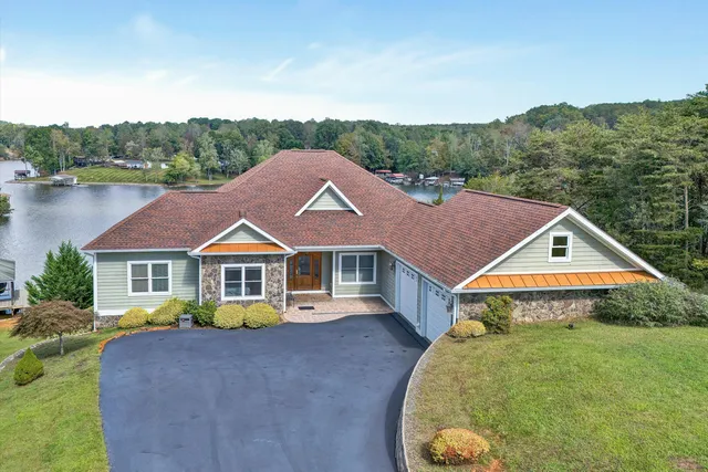 a view of a hallway with wooden floor and windows