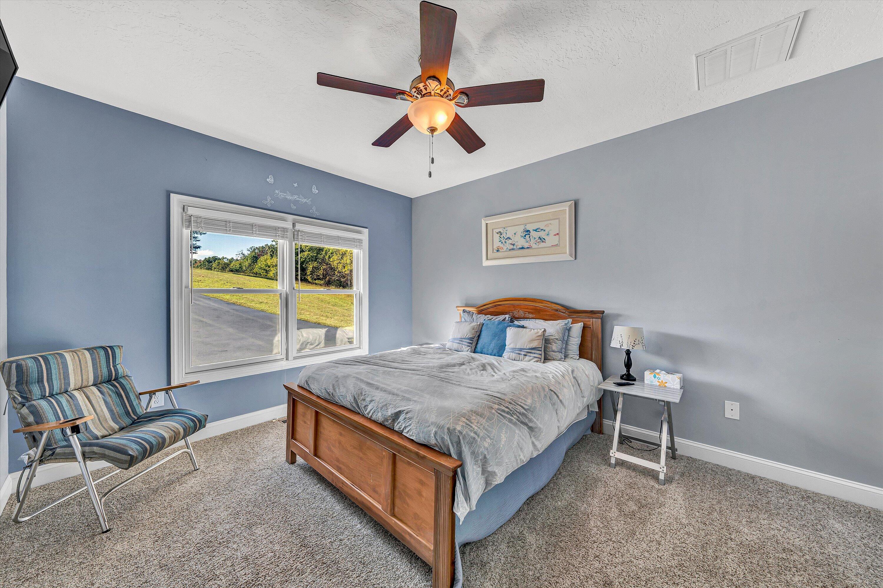 440 Augusta Way Wirtz, VA 24184 - Photo 26 of 63 a bedroom with a bed and a chandelier