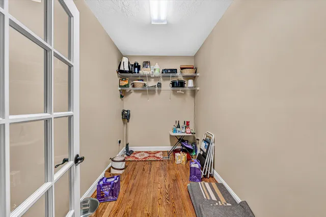 a living room with furniture flat screen tv and wooden floor