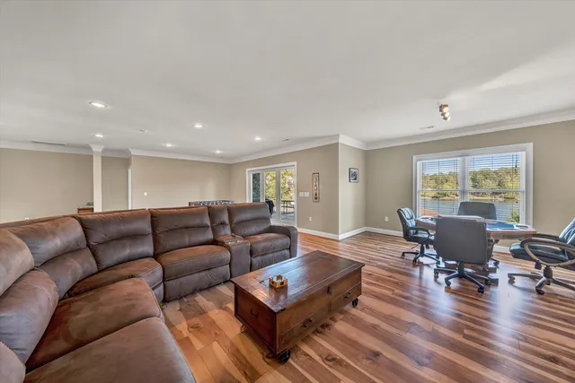 a spacious bedroom with a bed and a chandelier