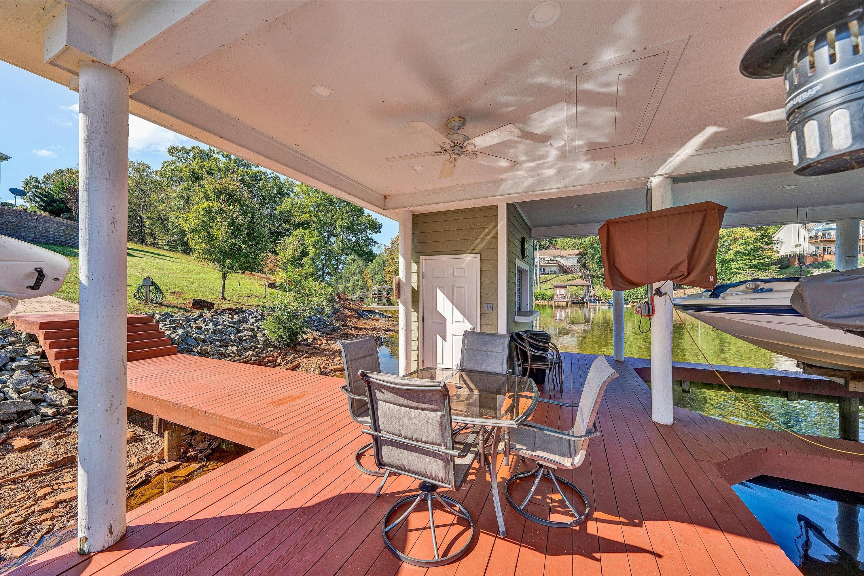 440 Augusta Way Wirtz, VA 24184 - Photo 48 of 63 a view of a patio with table and chairs potted plants with wooden floor and fence