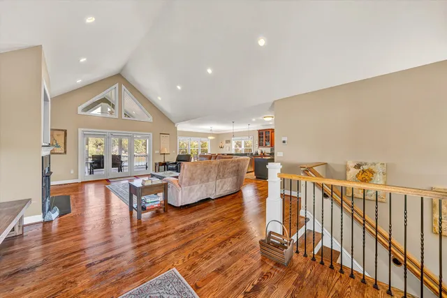 a living room with furniture fireplace and wooden floor