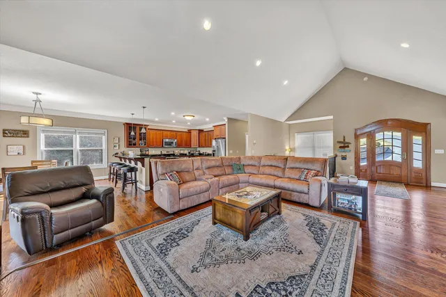 a kitchen with stainless steel appliances granite countertop a refrigerator a stove and a sink