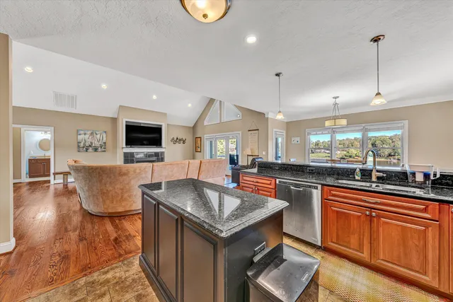 a kitchen with stainless steel appliances granite countertop a sink stove and microwave