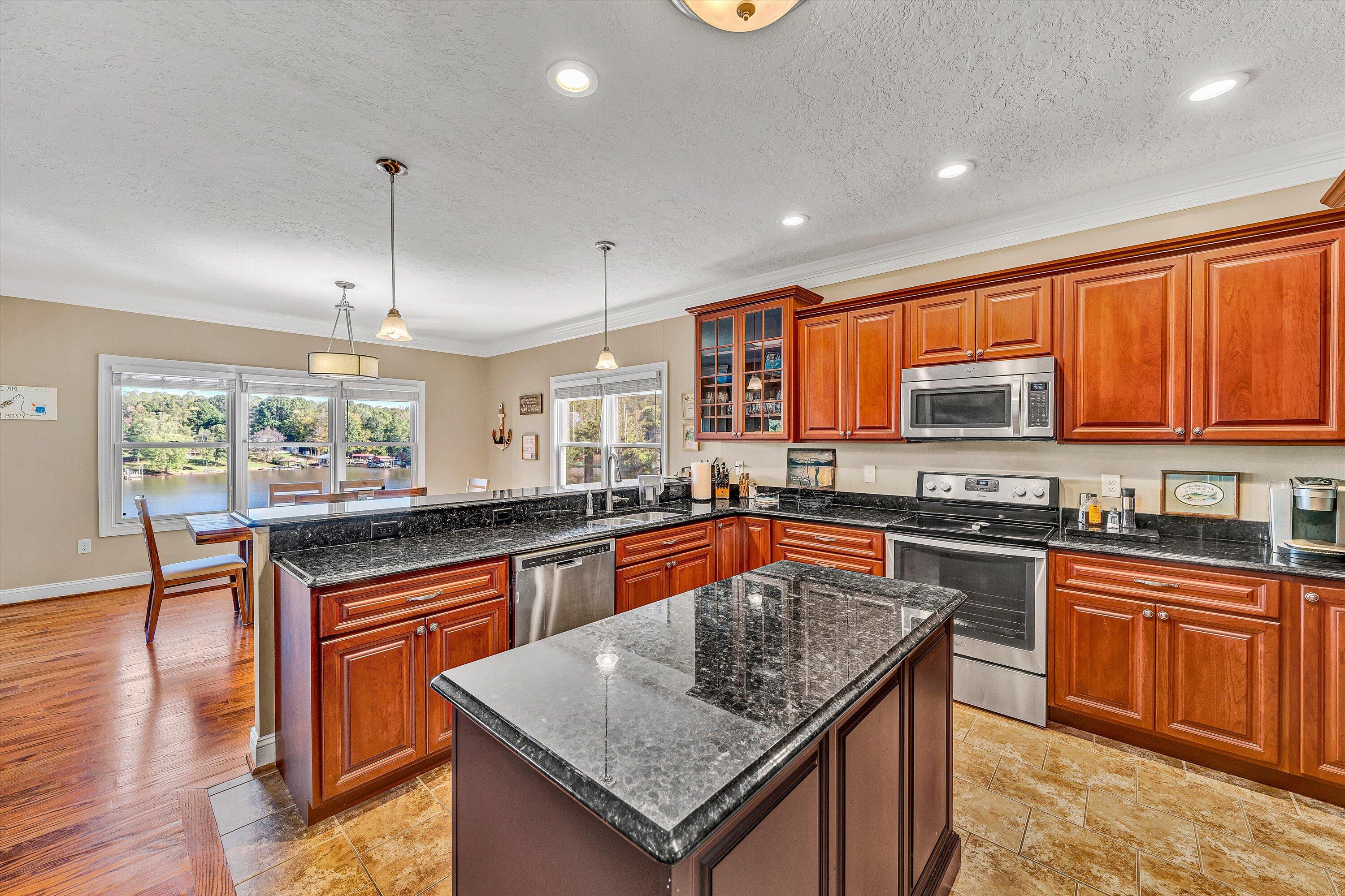 440 Augusta Way Wirtz, VA 24184 - Photo 10 of 63 a kitchen with stainless steel appliances granite countertop wooden cabinets counter space and a window