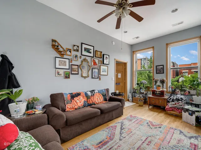 a living room with furniture ceiling fan and a rug