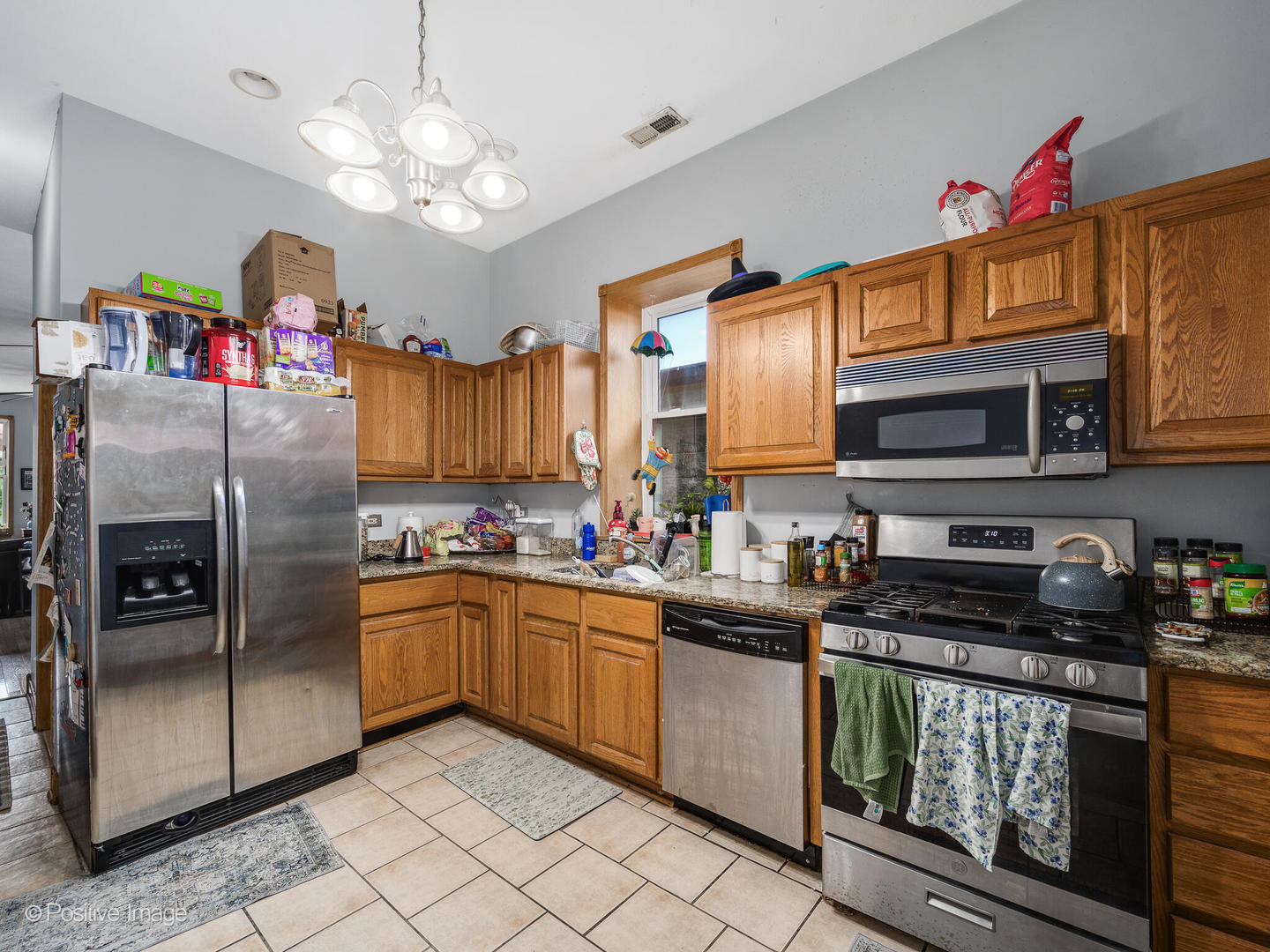 1517 West Taylor Street Chicago, IL 60607 - Photo 20 of 27 a kitchen with granite countertop stainless steel appliances a sink dishwasher a refrigerator a stove top oven a chimney and cabinets