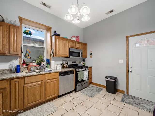 a kitchen with cabinets a sink and appliances
