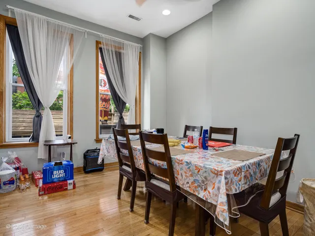 a view of a dining room with furniture and a window