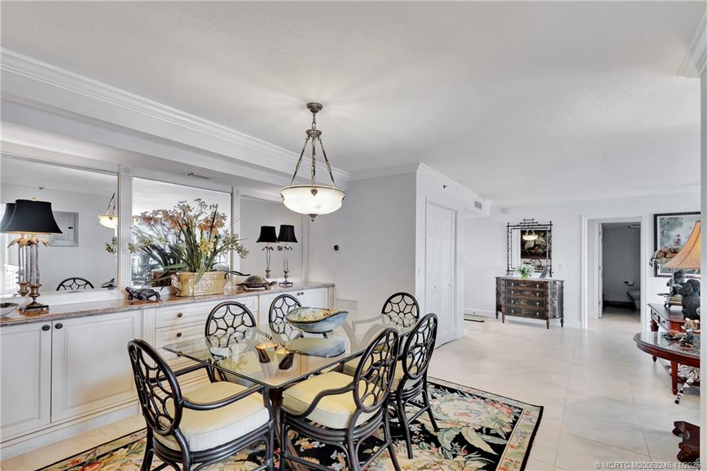 500 Ocean Drive, Unit W11 North Palm Beach, FL 33408 - Photo 11 of 77 a view of a dining room and livingroom with furniture wooden floor a chandelier