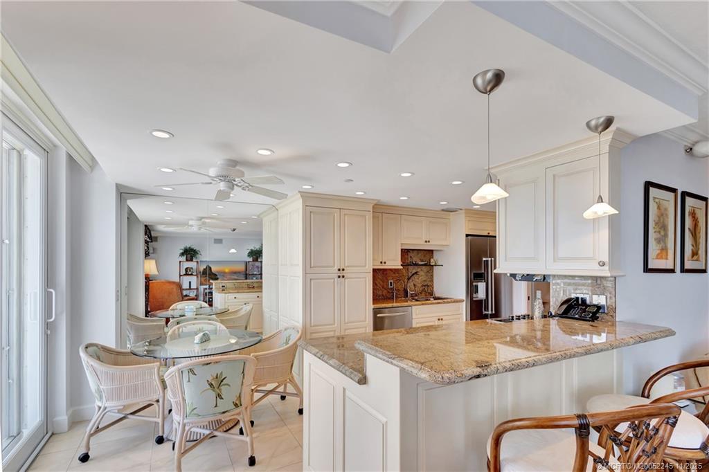 500 Ocean Drive, Unit W11 North Palm Beach, FL 33408 - Photo 15 of 77 a kitchen with stainless steel appliances kitchen island granite countertop a sink and cabinets