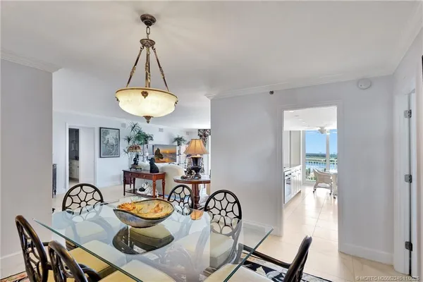 a kitchen with stainless steel appliances granite countertop a stove a sink and white cabinets with wooden floor