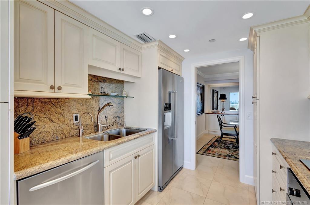 500 Ocean Drive, Unit W11 North Palm Beach, FL 33408 - Photo 18 of 77 a spacious bathroom with a sink and a mirror