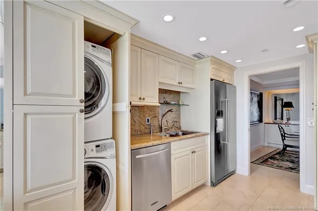a bathroom with a granite countertop sink a toilet and a mirror