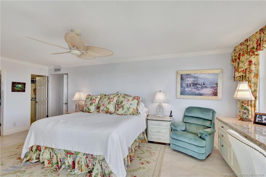 500 Ocean Drive, Unit W11 North Palm Beach, FL 33408 - Photo 25 of 77 a bedroom with a bed and a chandelier