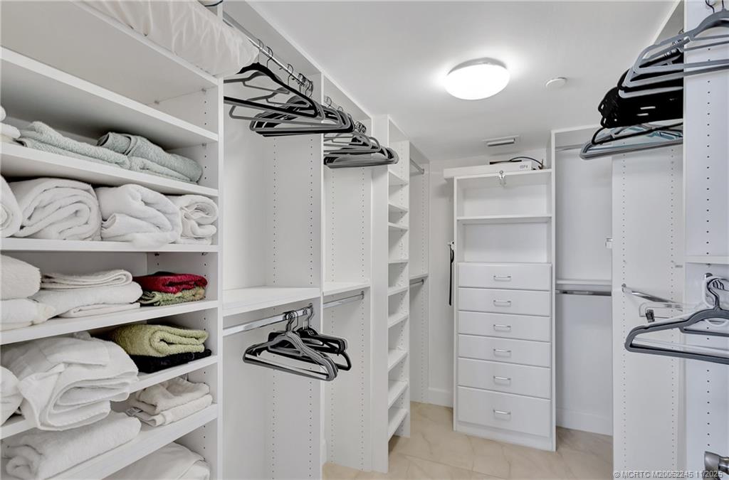 500 Ocean Drive, Unit W11 North Palm Beach, FL 33408 - Photo 29 of 77 a view of walk in closet with clothes and shoes
