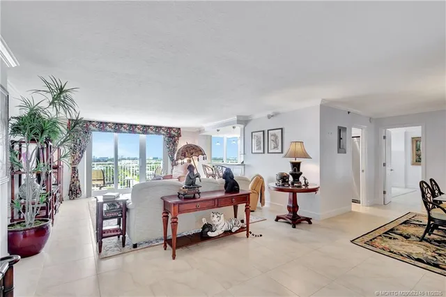 a living room with furniture and a floor to ceiling window