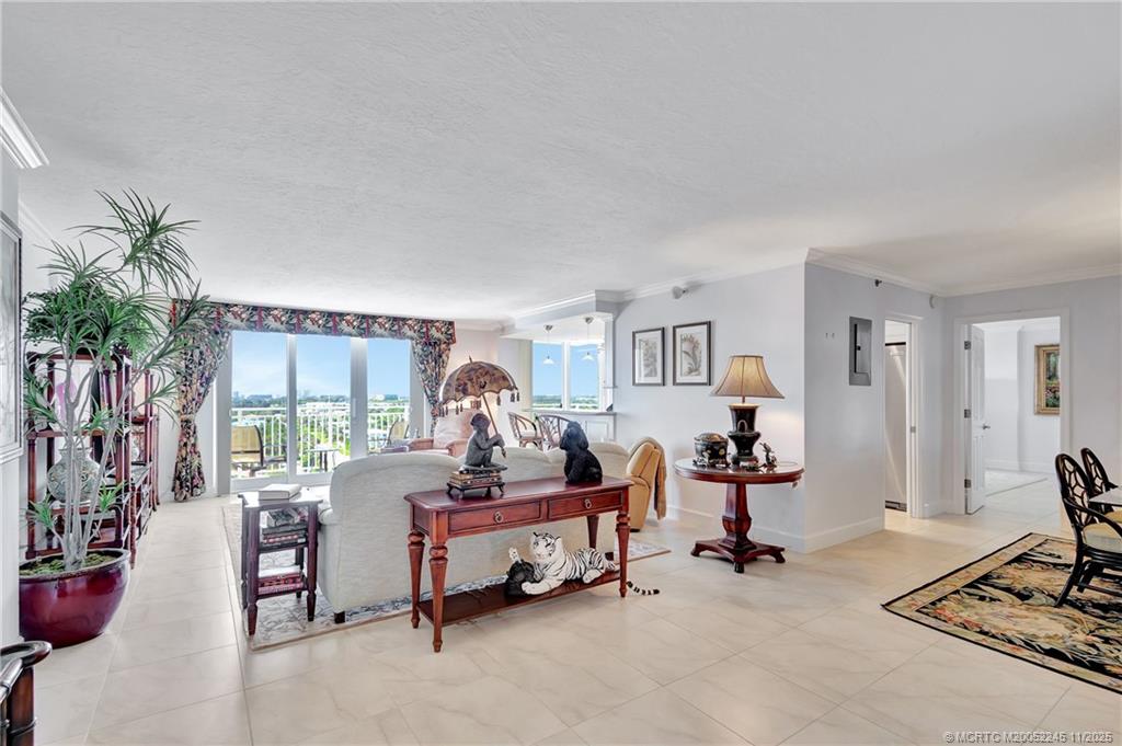 500 Ocean Drive, Unit W11 North Palm Beach, FL 33408 - Photo 3 of 77 a living room with furniture gym equipment and a potted plant