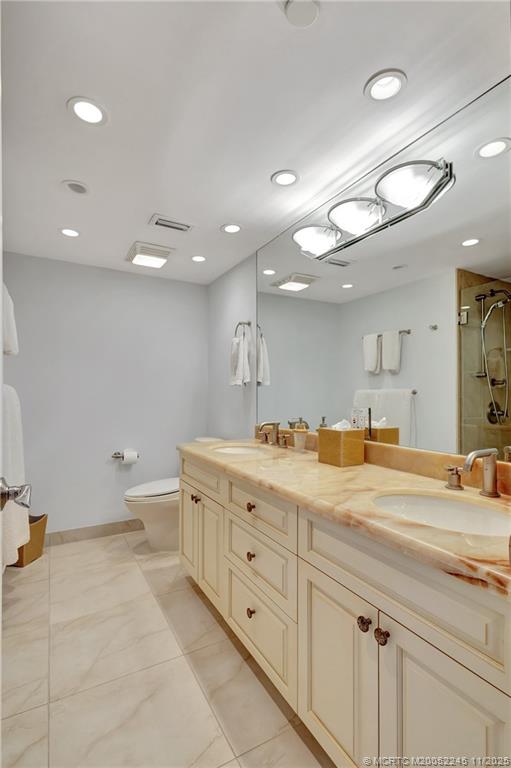 500 Ocean Drive, Unit W11 North Palm Beach, FL 33408 - Photo 34 of 77 a spacious bathroom with a granite countertop sink a toilet and a mirror