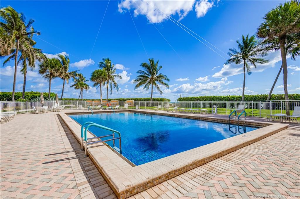 500 Ocean Drive, Unit W11 North Palm Beach, FL 33408 - Photo 69 of 77 a view of swimming pool with a table and chairs under an umbrella