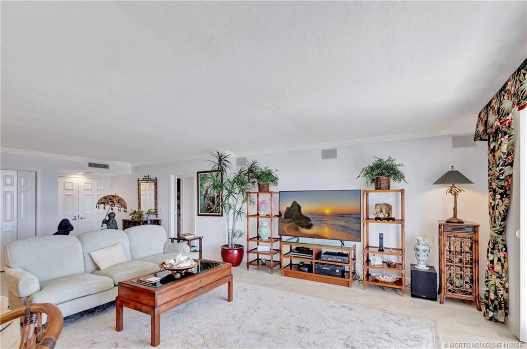500 Ocean Drive, Unit W11 North Palm Beach, FL 33408 - Photo 7 of 77 a living room with furniture and a flat screen tv