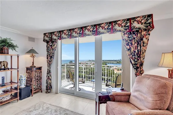 a view of a dining room and livingroom with furniture wooden floor a chandelier