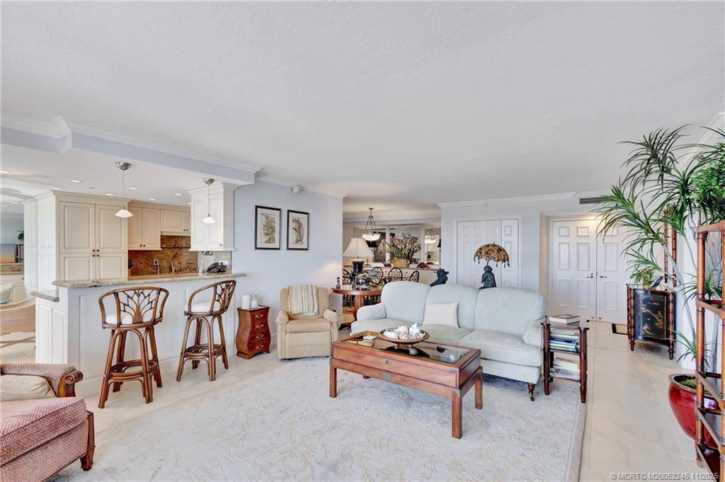 500 Ocean Drive, Unit W11 North Palm Beach, FL 33408 - Photo 9 of 77 a living room with furniture and a dining table with wooden floor