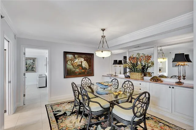 a dining room with furniture a chandelier and wooden floor