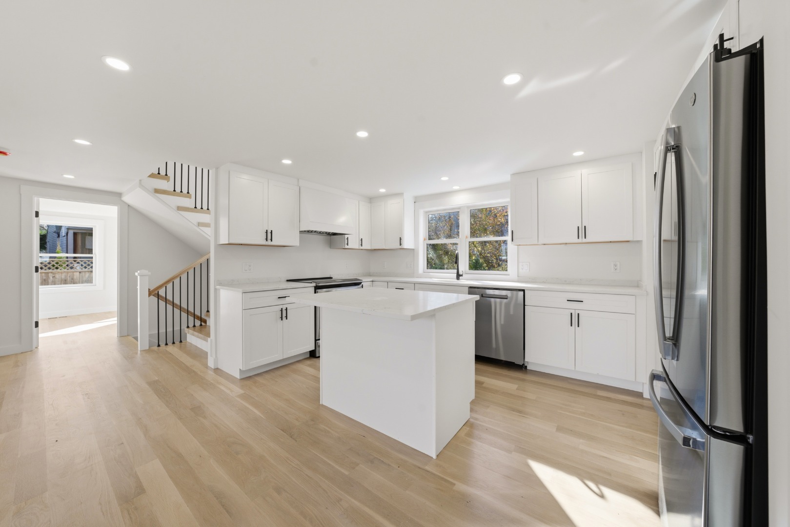38 Hooper Farm Road Nantucket, MA 02554 - Photo 8 of 19 a kitchen with kitchen island white cabinets and stainless steel appliances
