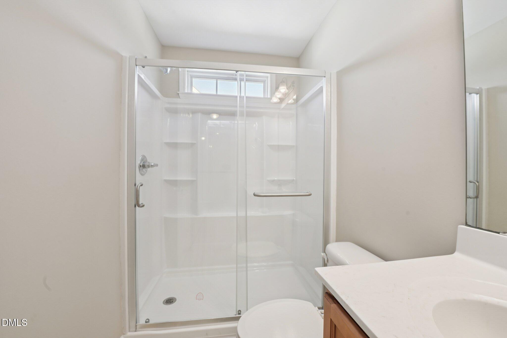 11 Hidden Ridge Court Durham, NC 27707 - Photo 25 of 30 a bathroom with a shower a toilet and sink