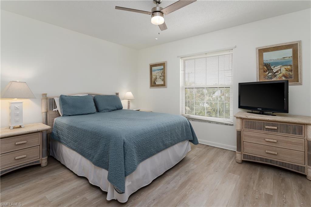 116 Clyburn Street, Unit C6 Marco Island, FL 34145 - Photo 14 of 32 a bedroom with a bed and a flat screen tv