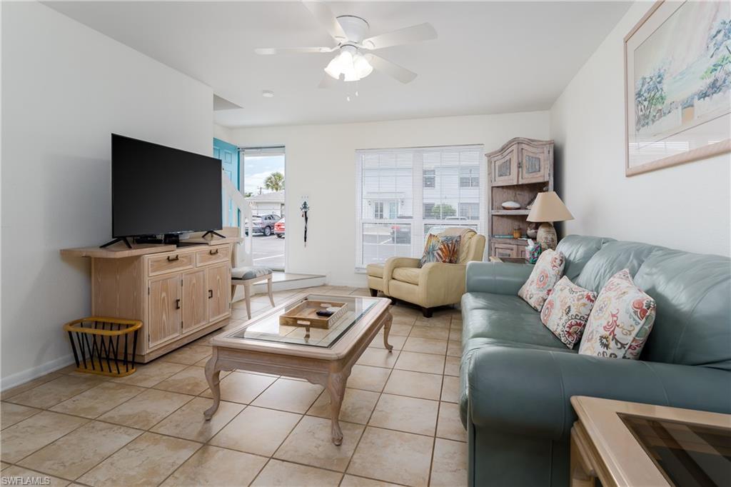 116 Clyburn Street, Unit C6 Marco Island, FL 34145 - Photo 5 of 32 a living room with furniture and a flat screen tv