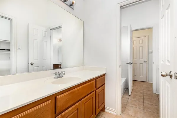 a bathroom with a sink a mirror and a shower