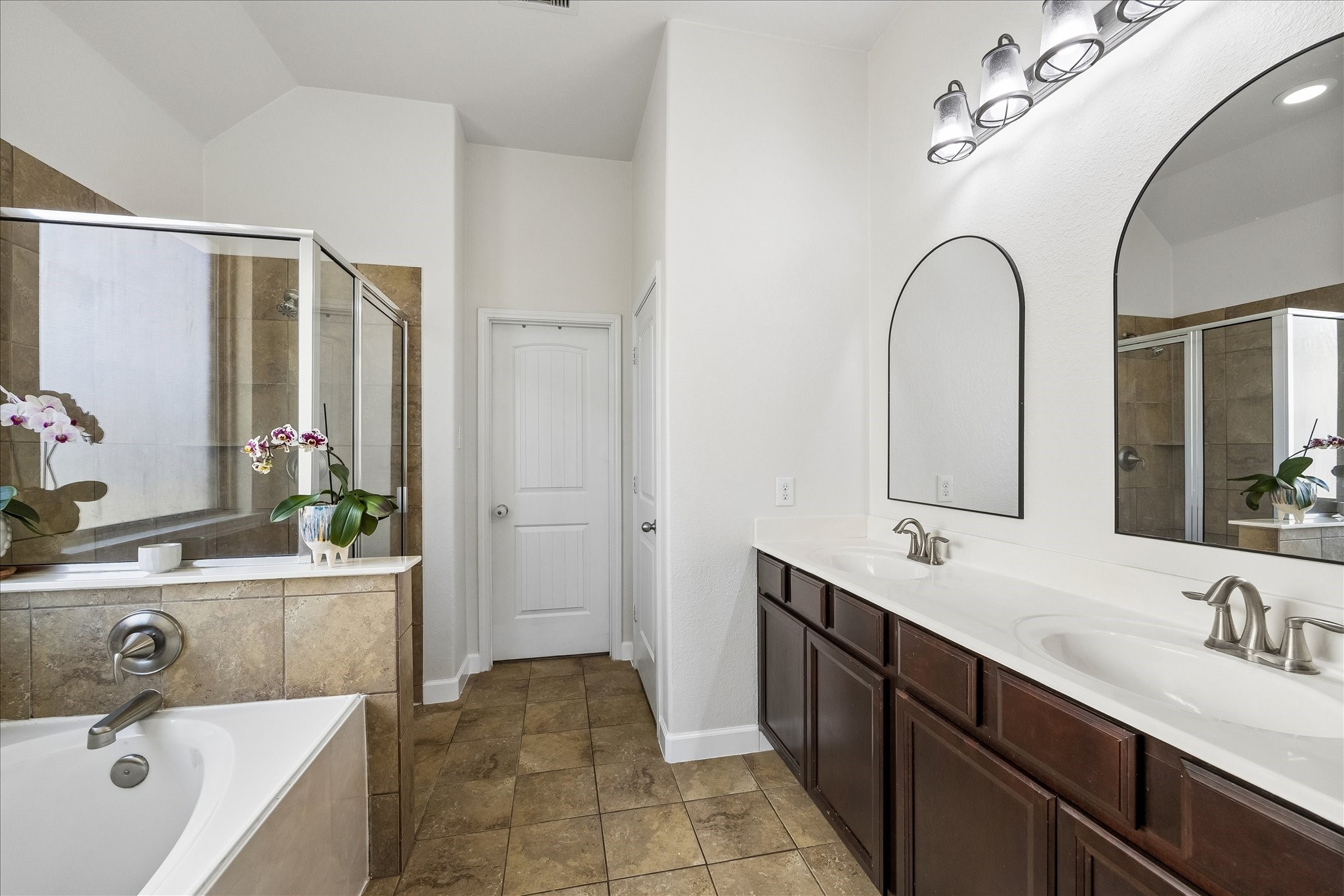 326 Ralston Ranch Court Richmond, TX 77469 - Photo 15 of 28 The ensuite primary bathroom features a dual-sink vanity, a large glass enclosed walk-in shower and a relaxing soaking tub.