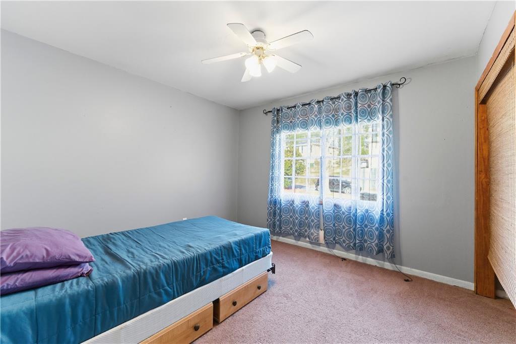 3033 Thrasher Circle Decatur, GA 30032 - Photo 11 of 25 a bedroom with a bed and a chandelier