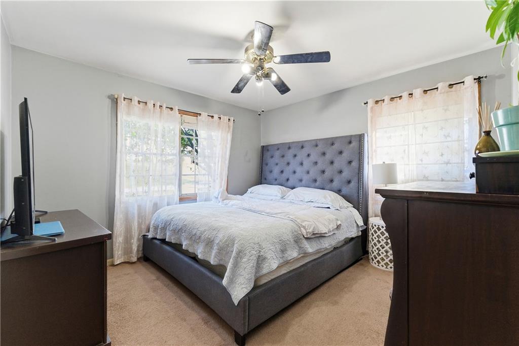 3033 Thrasher Circle Decatur, GA 30032 - Photo 12 of 25 a large bed sitting in a bedroom next to a window