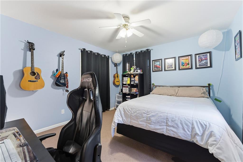 3033 Thrasher Circle Decatur, GA 30032 - Photo 15 of 25 a bedroom with bed and a chandelier