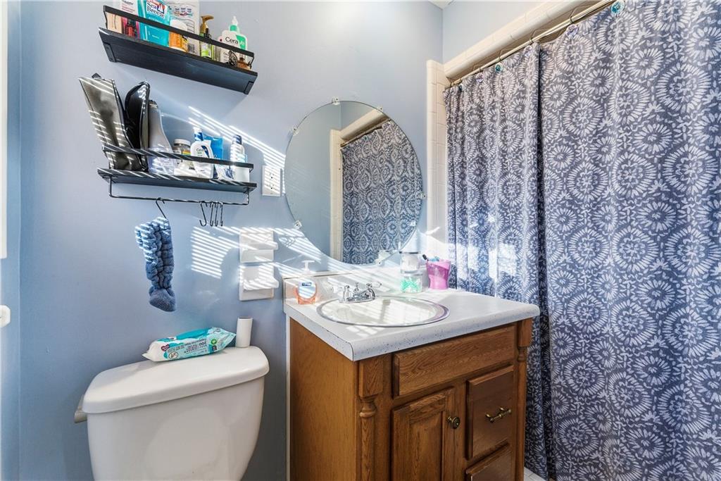 3033 Thrasher Circle Decatur, GA 30032 - Photo 16 of 25 a bathroom with a sink a toilet and a mirror