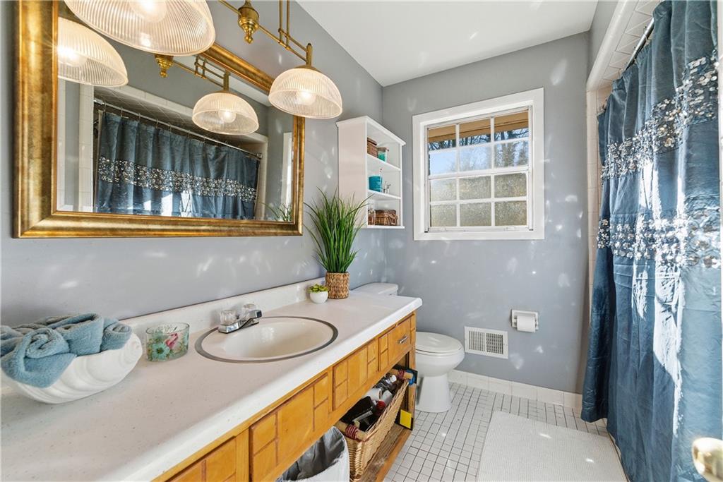 3033 Thrasher Circle Decatur, GA 30032 - Photo 17 of 25 a bathroom with a granite countertop sink and a mirror